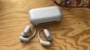 lavender soundcore aerofit 2 pro earbuds and case on wooden tabletop